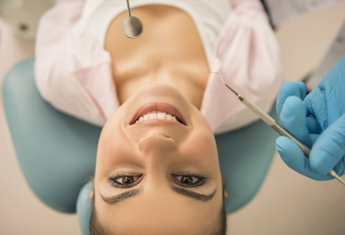 young woman in dental chair looking up